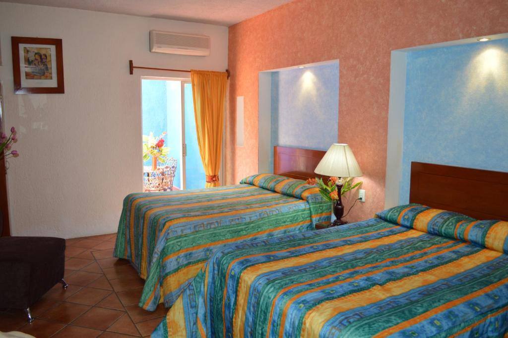 Room with two full beds at Hotel La Rienda Mision Tequillan